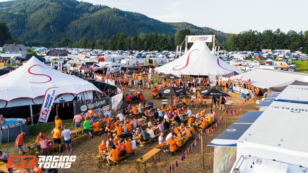 A large outdoor event with tents and a crowd of people.