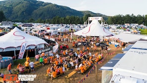 A large outdoor event with tents and a crowd of people.