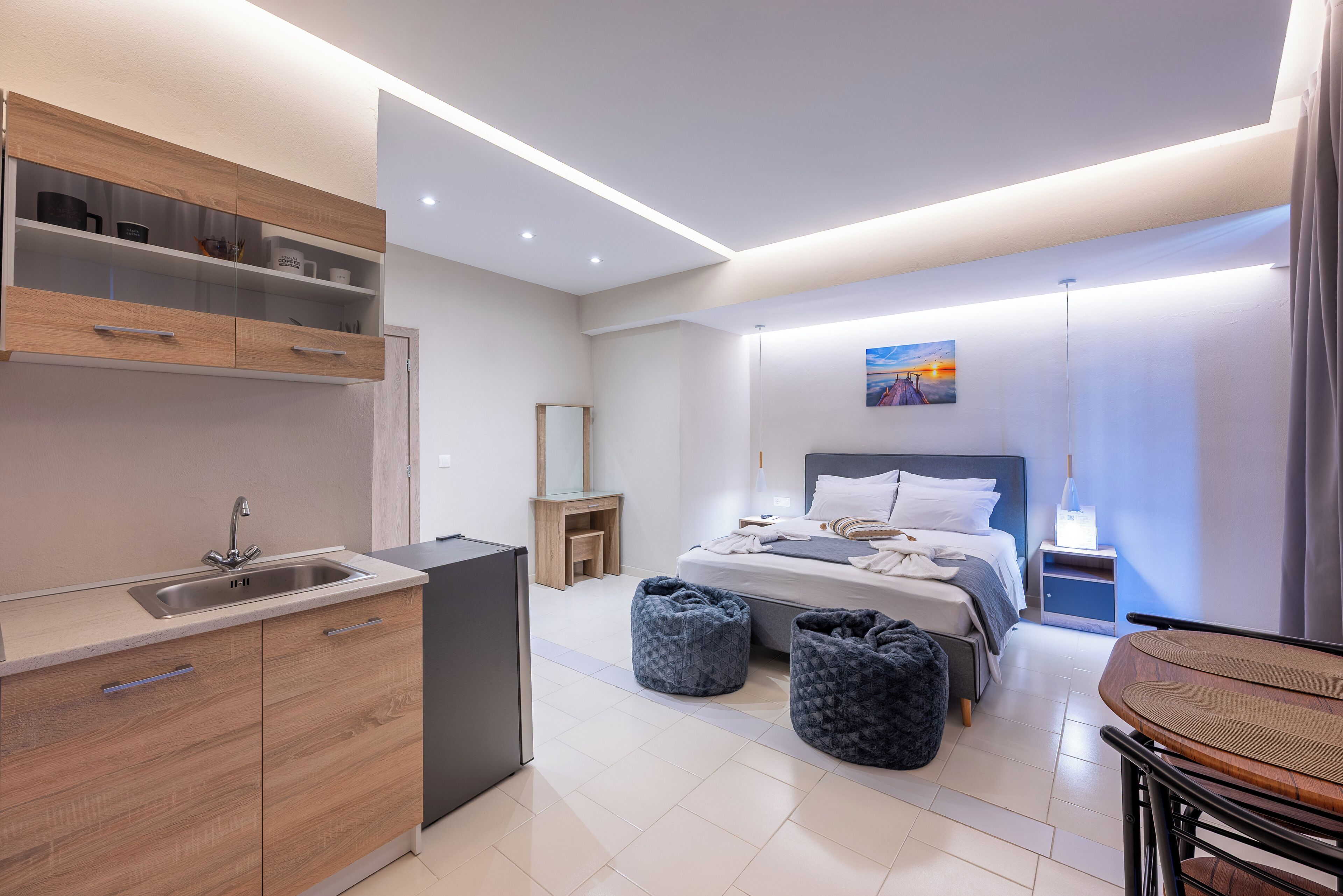 A modern bedroom with a bed, bedside table, and a nightstand.