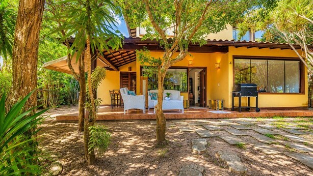 A house with a patio, outdoor furniture, and a grill.
