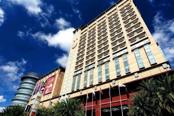 A tall hotel with multiple floors and a prominent cylindrical structure to the left. - Nice Prince Hotel (Chiayi City)