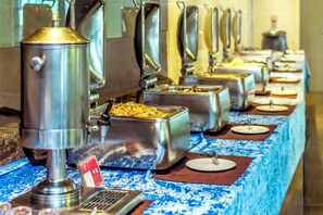 A buffet setup with various food containers and a coffee machine. - Xiyue Holiday Hotel (Chongqing Liangping New City Branch) (Chongqing)