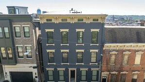 A multi-story building with a central entrance, large windows, and a flat roof.