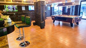 A billiards table, a bar area with stools, and a television screen. - Patong Rockshore  (Patong)