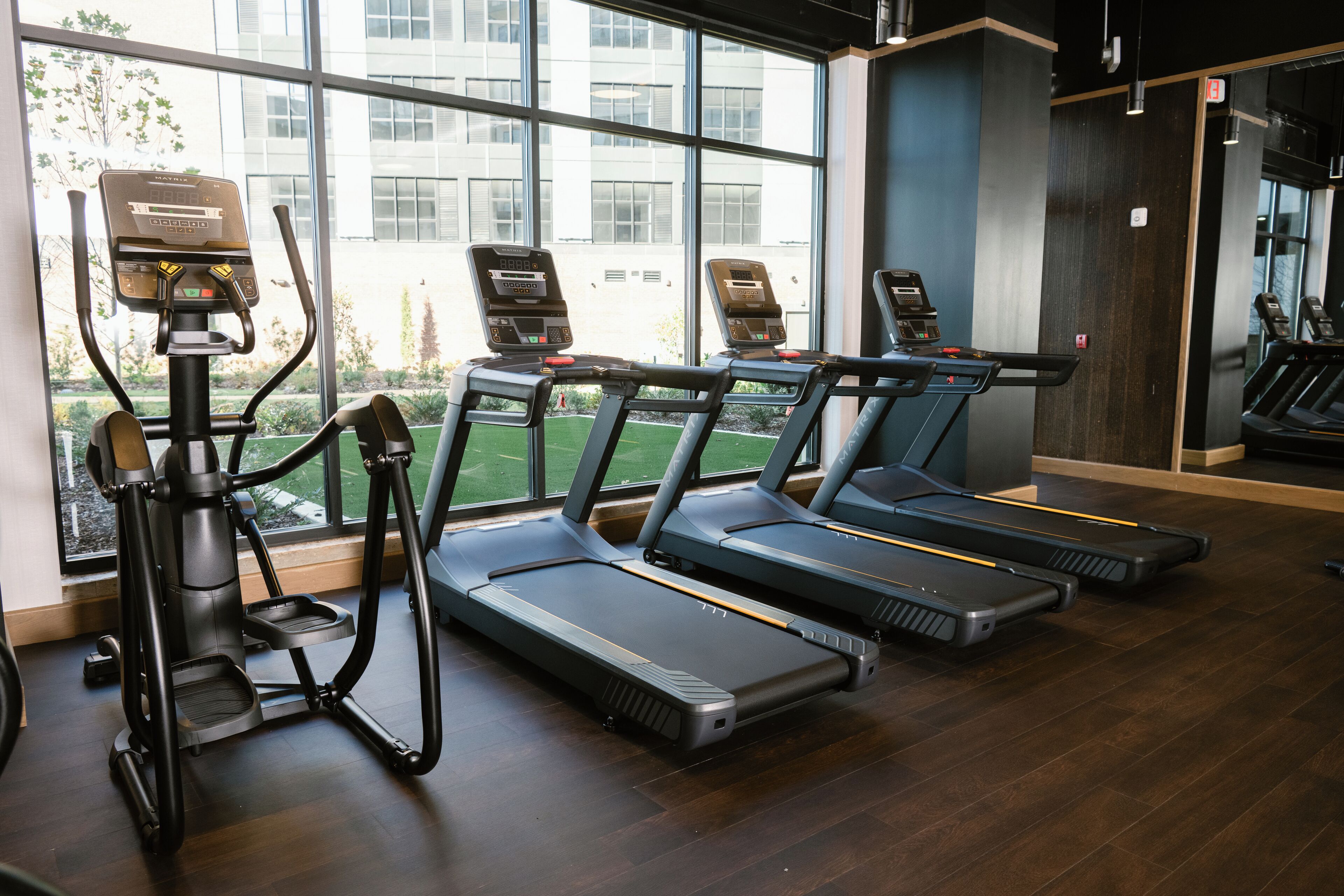 A gym with treadmills, ellipticals, and a rowing machine.