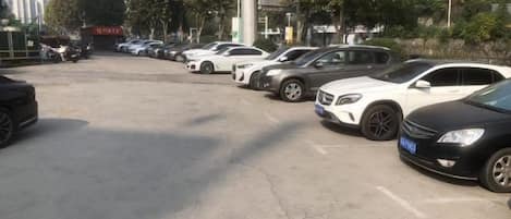 A parking lot with multiple cars parked in rows.
