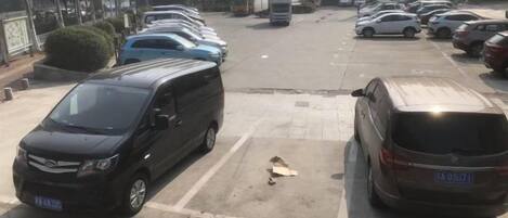 A parking lot with multiple cars parked in designated spaces.