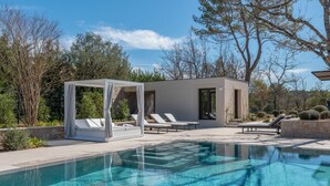 A modern outdoor pool area with a cabana, lounge chairs, and a clear blue pool. - Residence Anabelle - Four Bedroom Villa, Sleeps 8 (Tourrettes)
