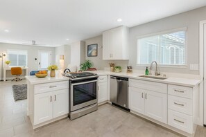 A modern kitchen with white cabinetry, a built-in oven, and a dishwasher. - Three Private Units| Pool/Spa|Downtown|Freeways|Beaches (San Diego)