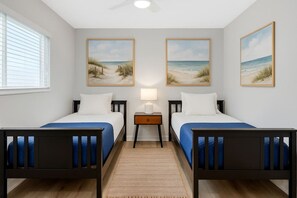 A hotel room with two beds, a nightstand, a lamp, and beach-themed wall art. - 5-Units/26 guests/Heated Pool Option/Spa (San Diego)