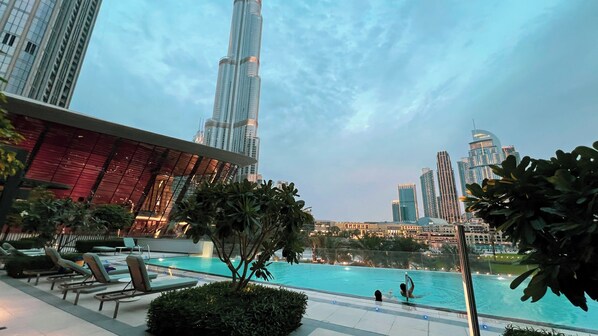 Outdoor pool, open 7:00 AM to 10:00 PM, pool umbrellas, sun loungers