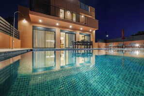A modern two-story building with a swimming pool, outdoor seating, and a balcony. - Madre Tierra Boutique Villa 1 (FXM6+46P Oasis, Greece)