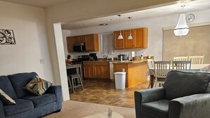 A living room with a sofa, armchair, and a coffee table. - Charming 3-bedroom house in  wonderful and fascinating Berlin, MD. (Berlin)