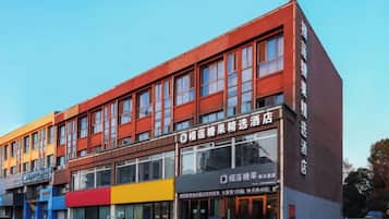 A multi-story building with a storefront featuring a large glass window and signage.