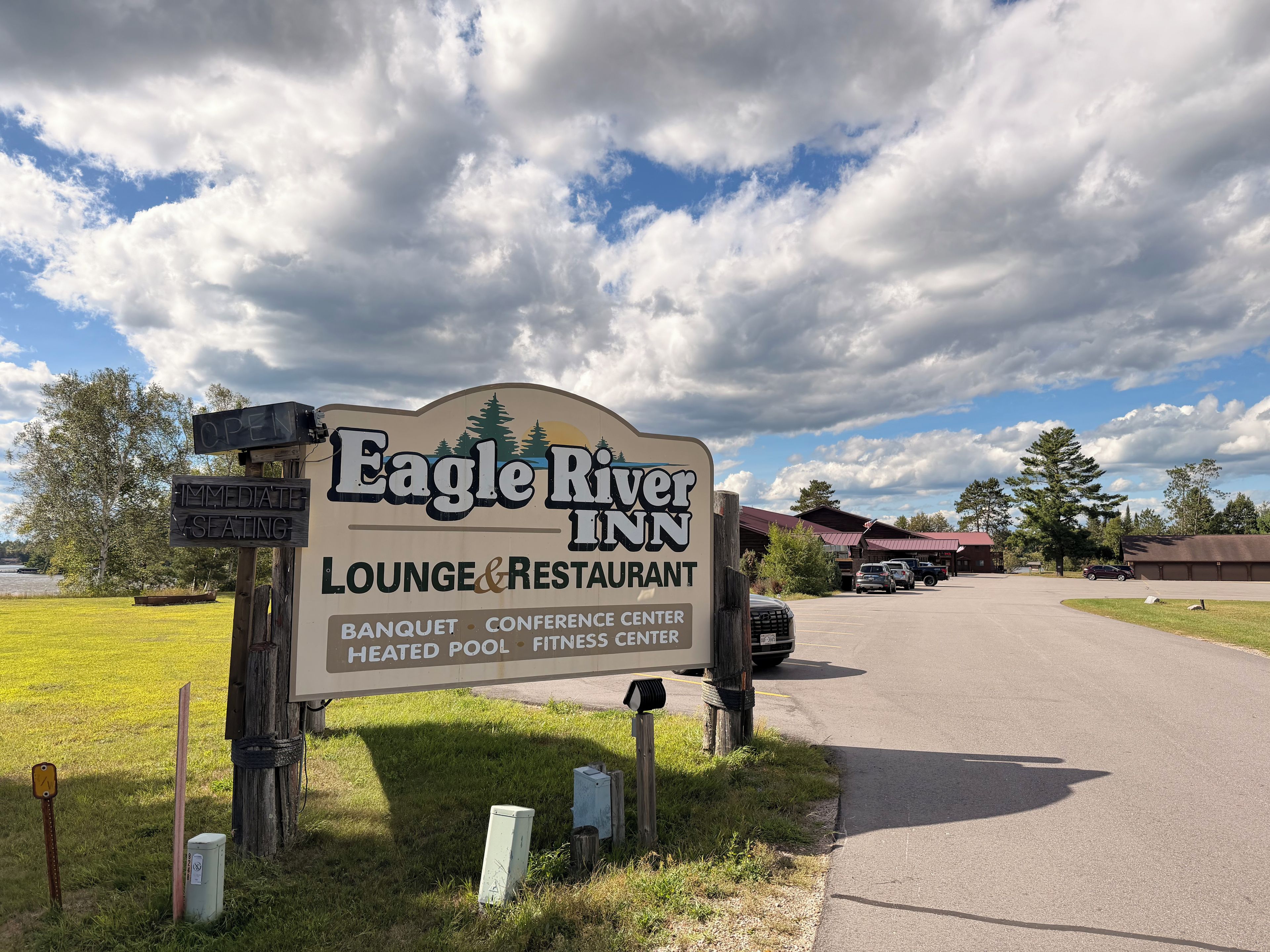 A sign for Eagle River Inn, indicating it is a lounge and restaurant with amenities like a banquet, conference center, heated pool, and fitness center.