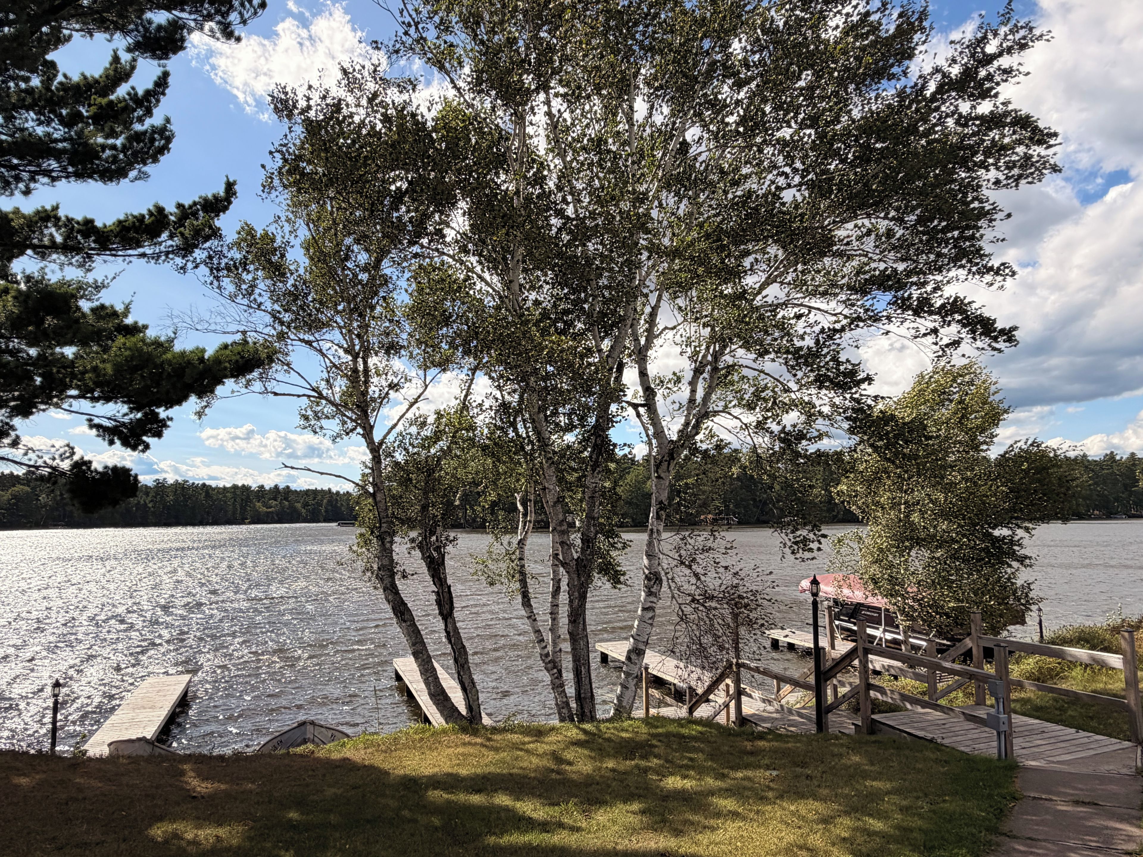 Une vue sur le lac, avec un quai en bois et un belvédère.