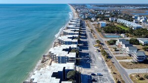A coastal residential area with beachfront properties, a main road, and a parking lot. - Oceanfront Comfort at "Coastal Wonderland" (North Topsail Beach)