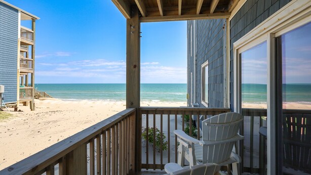 A wooden deck with a view of the beach and ocean. - Oceanfront Comfort at "Coastal Wonderland" (North Topsail Beach)
