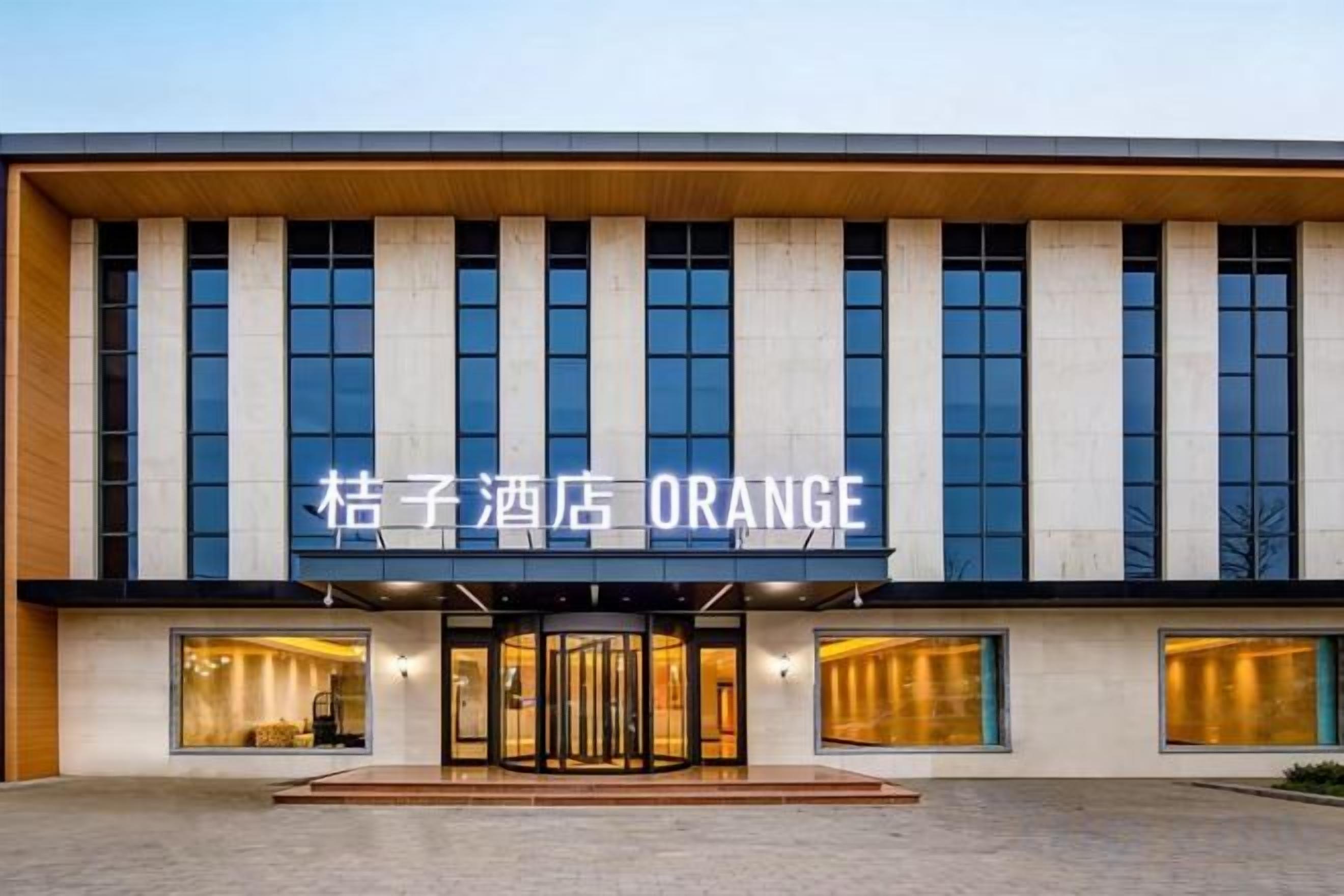 A hotel with a modern facade, large windows, and a prominent entrance.