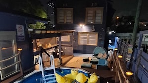 A swimming pool with a yellow inflatable duck float and a ladder. - Blue Little Havana (Miami)