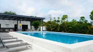 A swimming pool with a covered area and steps leading into it.