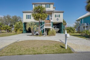 A two-story house with a front porch, a staircase, and a mailbox. - Marina & Golf Course Views: Edisto Island Home (Edisto Island)