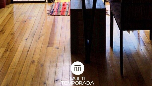 A wooden deck with a table and chairs, overlooking a forested area. - Cabana Fruta Fina - Urubici - SC (Urubici)