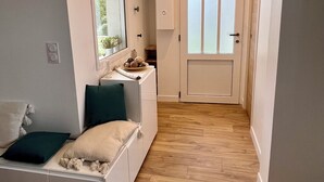 A compact room with a bed, a small desk, and a window.