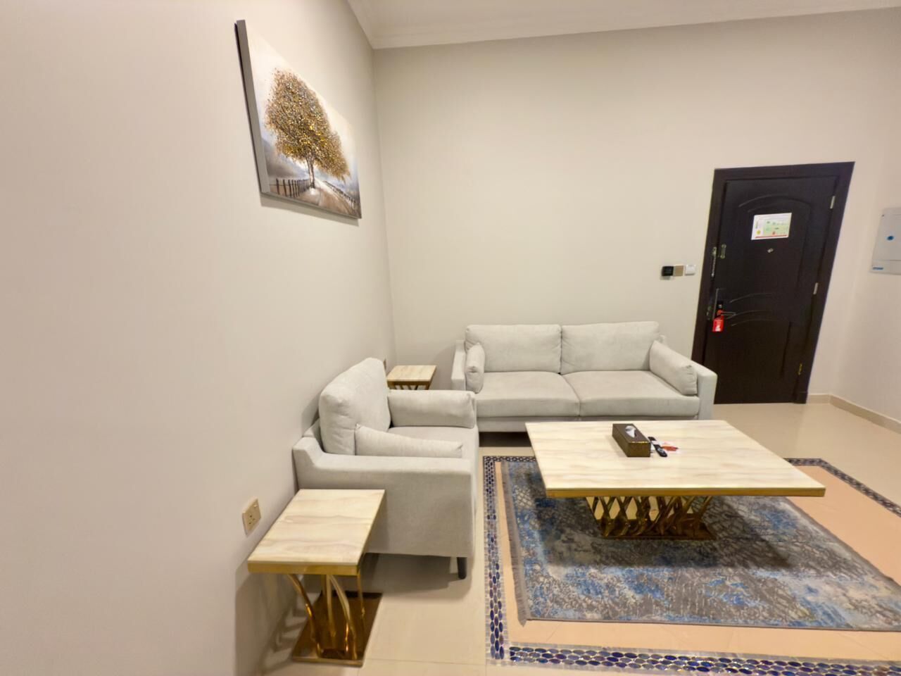 A modern living room with a sofa, two side tables, and a coffee table.