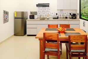 A kitchen with a stainless steel refrigerator, a microwave, a toaster, and a coffee maker on the counter. - Villa Bruno - Jungle Eco-Luxury - Ocean Views - Wildlife - Wifi - Hot Water (Puerto Jimenez)