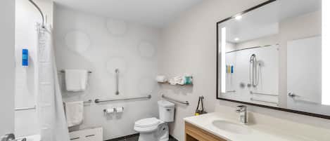A modern bathroom with a toilet, sink, and shower.