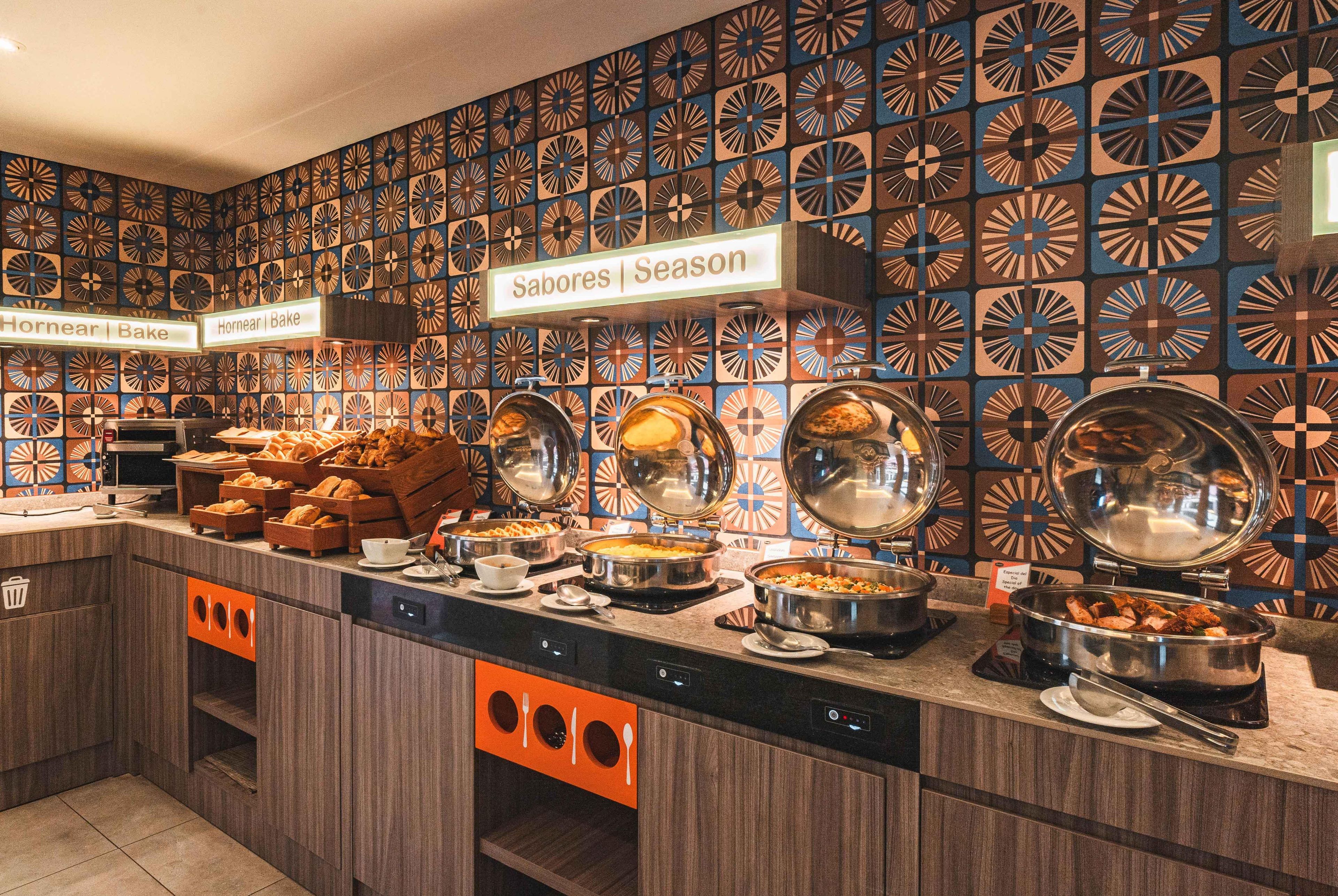 A buffet area with labeled sections for different food items, including a bake section and a special of the day.