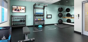 A gym with exercise equipment, a wall-mounted television, and a mirror. - Homewood Suites By Hilton Saltillo (Saltillo)