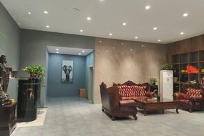 A spacious living area with a modern sofa set, a fireplace, and a large window. - Xunxian Guest House (Hebi Xunxian Ancient City Branch) (Xun County)