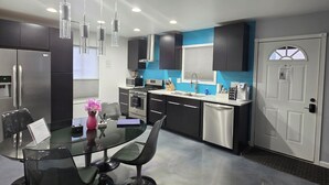 A modern kitchen with a dining area. - Modern/Retro 1br Condo by Exceptional Stays (High Point)