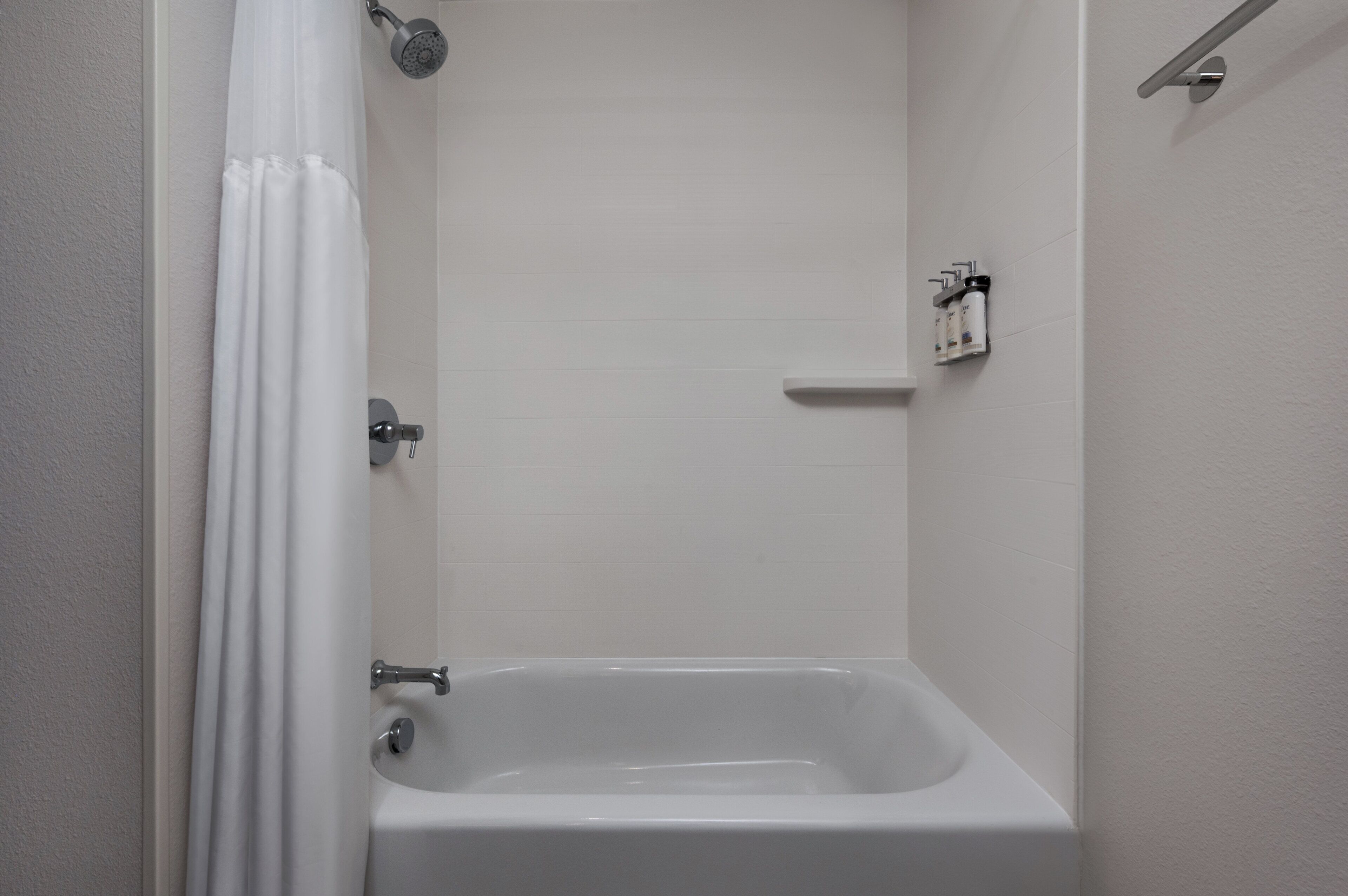 A bathroom with a bathtub, a shower, and a toilet.