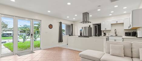 Relax in a spacious living area with a comfortable sofa and garden view.