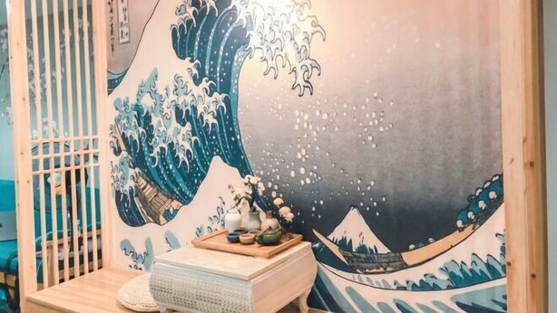 A room with a large wave painting on the wall, a wooden sideboard with a tray of items, and a traditional Japanese sliding door. - Weibo Inn (Shanghai Zhongshan Park) (Shanghai)