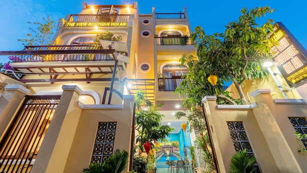 A multi-story building with balconies, a sign reading "The View Boutique Hoi An," and a mural of a traditional scene. - The View Boutique Hoi An (Da Nang)