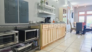 A kitchen with a built-in stove, oven, and microwave, wooden cabinets, and a countertop with a coffee maker and other appliances. - 3 Min to Lake Michigan, 15 Min to Ski Crystal (X) (Elberta)