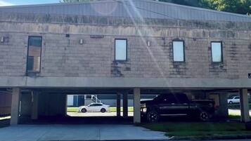 A two-story building with a flat roof and a parking garage.