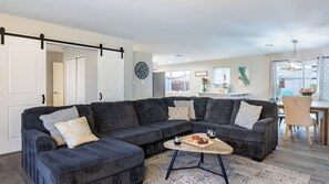 A modern living room with a sectional sofa, a coffee table, and a dining area with a table and chairs. - Private Pool + Outdoor Oasis 5mins to Old Town Indianola Oasis by Avantstay (Scottsdale)