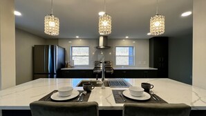 A modern kitchen with a large island, stainless steel appliances, and pendant lighting. - Private Heated Indoor Pool + No Neighbors + Ski Shawnee/Camelback (East Stroudsburg)