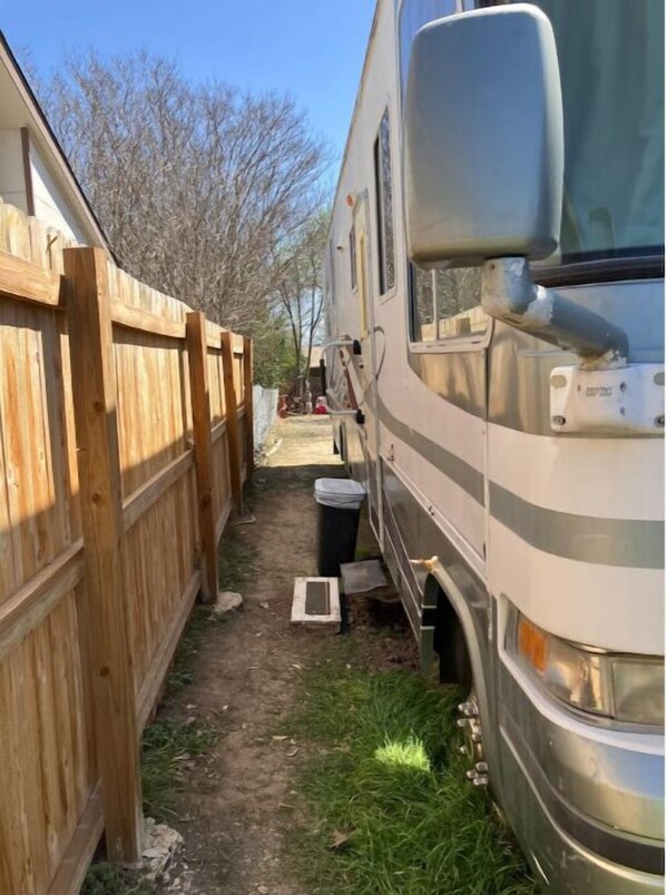 Guests can park their RVs adjacent to the building, surrounded by a grassy area.