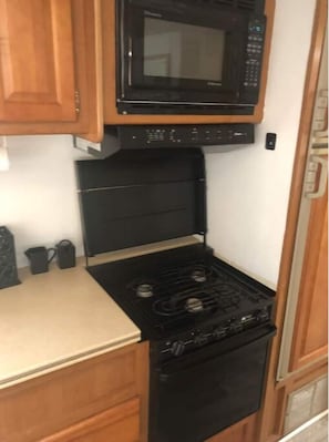 Enjoy cooking in this kitchen with a stove, microwave, and oven.
