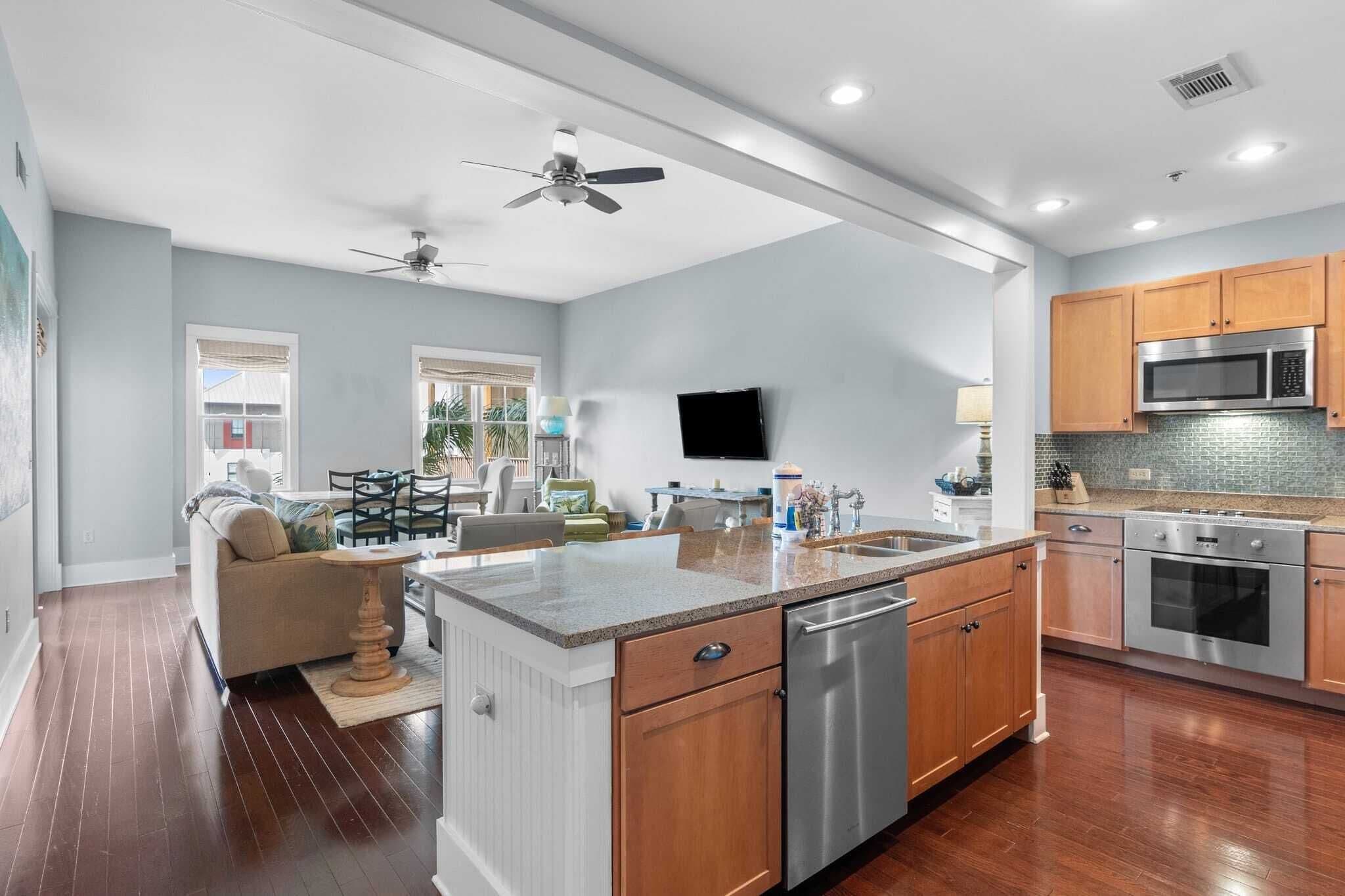 A spacious kitchen with wooden cabinets, stainless steel appliances, and a central island.