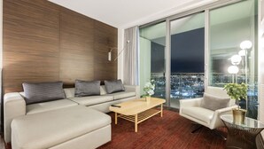 A modern living room with a sofa, armchair, and a coffee table. - SVS: Sunset View Studio | Open Balcony | Resort Amenities | Palms Place (Las Vegas)