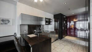 A modern kitchen with a central island, stainless steel appliances, and a dark wood countertop. - Strip View Studio • Balcony • No Resort Fee • Free Parking • TE25 (Las Vegas)