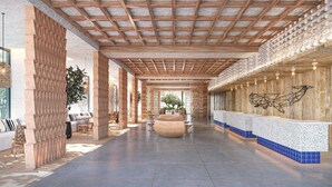 A modern lobby with a wooden ceiling, a reception desk, and a seating area with a large planter. - THE NEST NAHA (Naha)