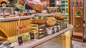 A buffet with various food items and a decorative centerpiece.